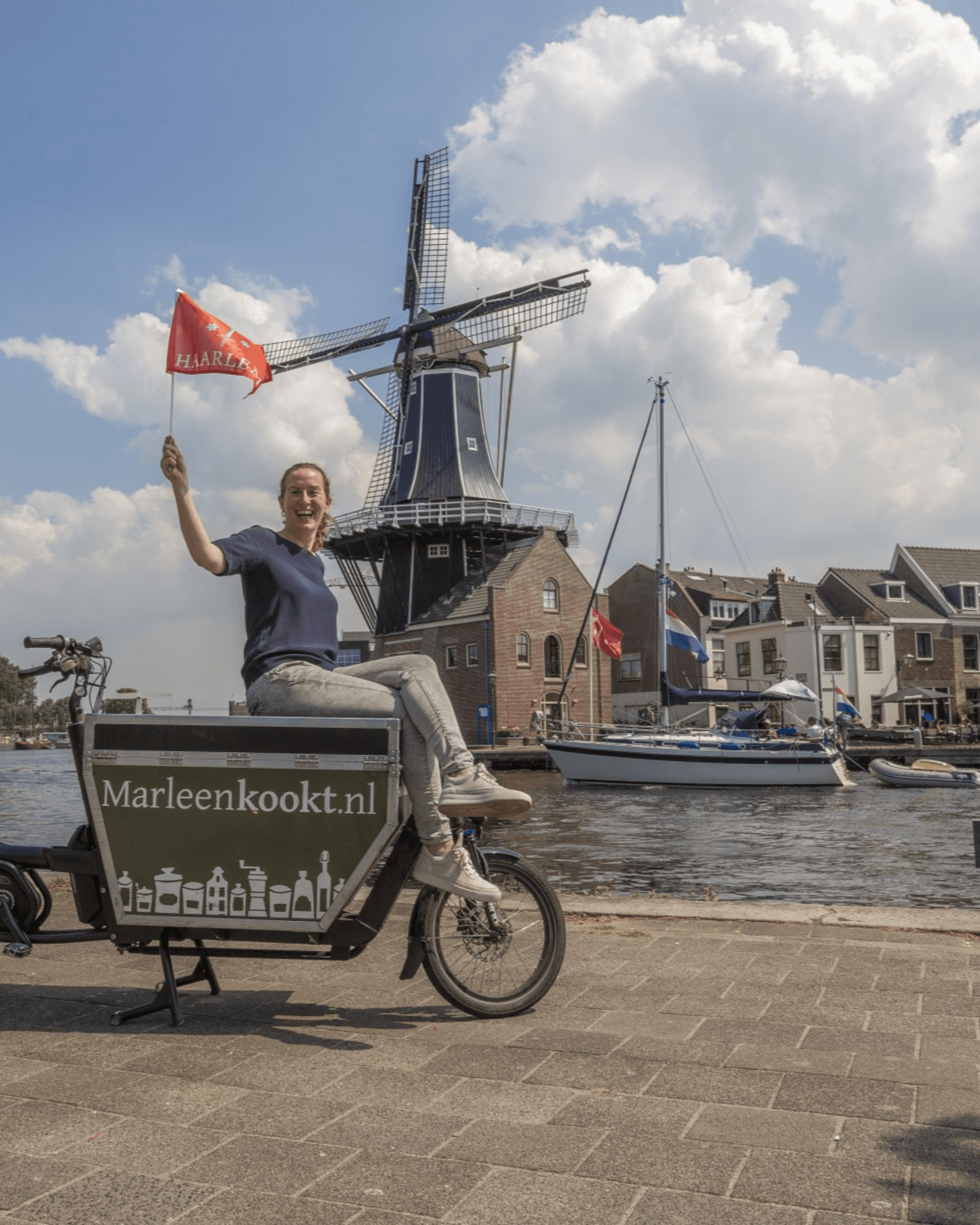 Marleen on the cargo bike by the windmill in Haarlem